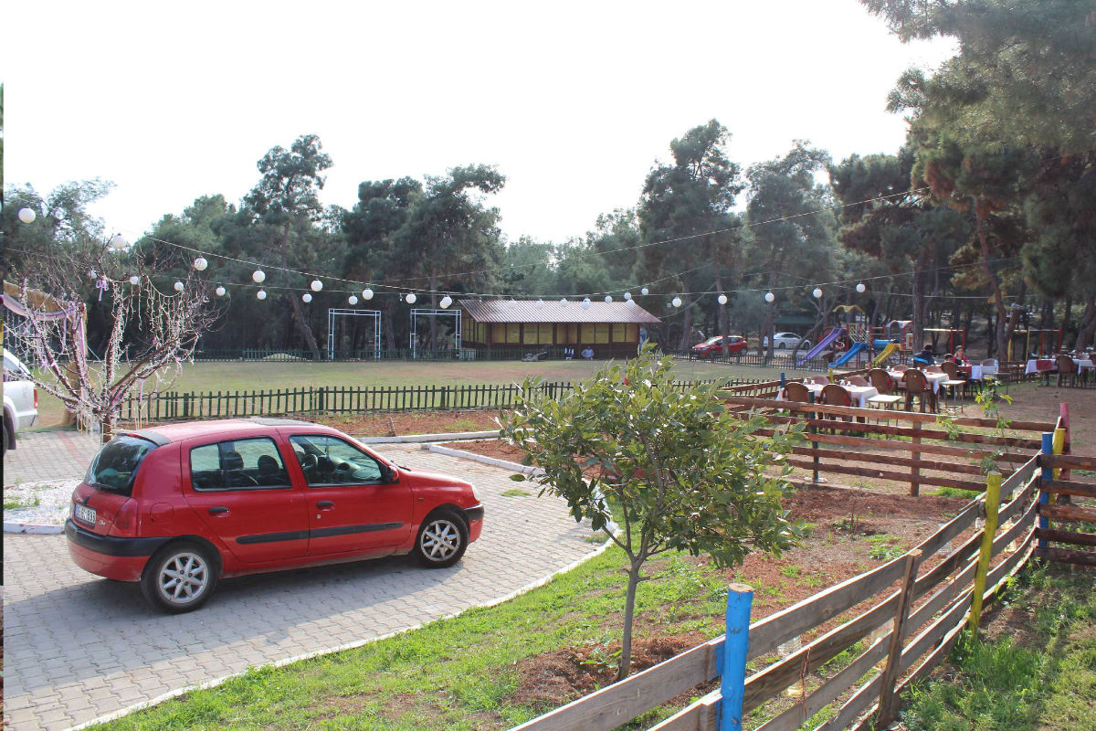 Grünfläche mit Sitzbereich, Spielplatz und Parkplatz im Kuyuluk Nature Park